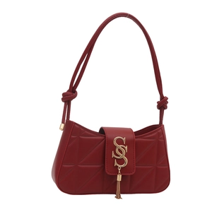 Quilted dark red underarm bag with golden S logo, fringe detail and knotted strap