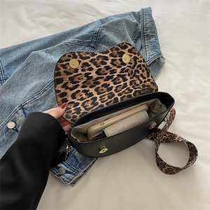 Minimalist black saddle bag with leopard print strap and interior for women