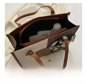 Top view showing spacious interior of the two-tone tote bag with daily essentials
