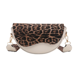 Minimalist cream saddle bag with leopard print flap and wide shoulder strap