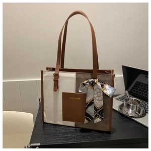 Detail view of contrast tote bag with a decorative silk scarf and fashion pocket detail