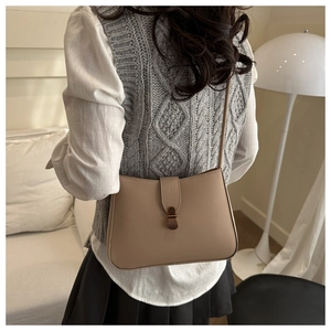 Detail of a chic apricot shoulder bag shown from a back view on a model for daily wear