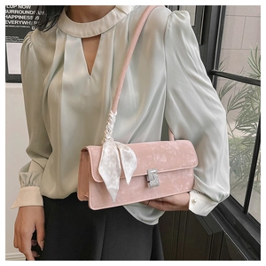 Pink velvet shoulder bag featuring a crystal S-buckle and elegant silk scarf detail