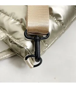 Detail of champagne quilted bag showing a durable plastic hook and detachable strap