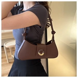 Dark brown leather underarm bag with gold-silver metal buckle and knotted strap details