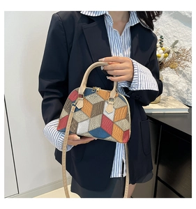 Close-up of geometric patchwork shell bag showing colorful leather textures and stitching