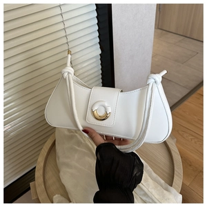 Detail of white leather shoulder bag featuring a modern dual-tone metal buckle and knotted strap