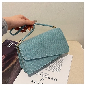 Détail du sac à main à paillettes bleu clair avec garniture dorée et structure à plis
