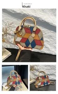 Detail view of khaki shell bag with vibrant geometric color block patchwork and gold hardware