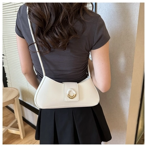 Minimalist white leather baguette bag for women showing crescent shape and gold buckle detail