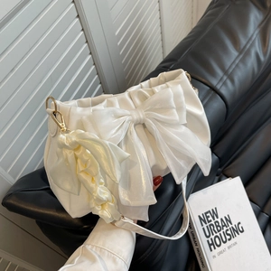 Creamy white cloud-shaped shoulder bag featuring a large bow and ruffled strap
