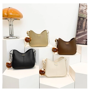Detailed display of vintage PU leather bucket bags in four colors with plush charms