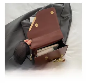 Interior capacity of burgundy leather crossbody bag showing space for phone and cardholder