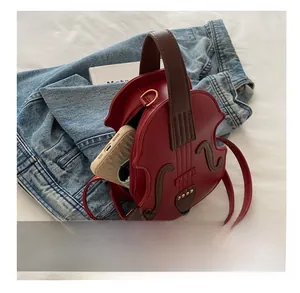Creative red violin shaped PU leather bag showing internal storage for a smartphone
