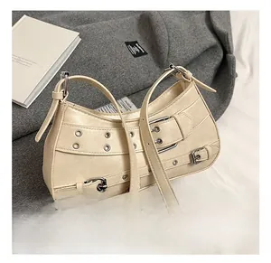 Detail of beige PU leather hobo bag featuring silver metal eyelets and belt buckle accents