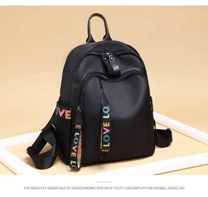Detail of waterproof nylon backpack featuring colorful LOVE letter straps and zippers