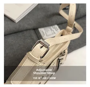 Detail of adjustable shoulder strap with silver metal buckle on beige faux leather bag