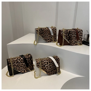 Detail of four leopard print crossbody bags in grey brown black and white with gold chains