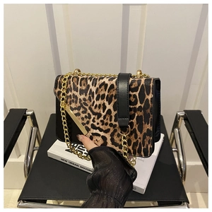 Detail of leopard print flap bag with gold metal trim and chunky chain strap