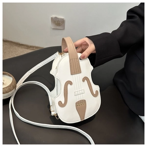 Detail of the violin shaped handbag with white PU leather and golden hardware accents