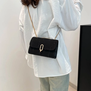 Denim fabric crossbody bag with distressed texture, golden chain, and oval buckle