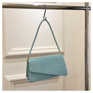 Détail du sac sous le bras bleu clair scintillant avec pli enveloppe et fine bandoulière