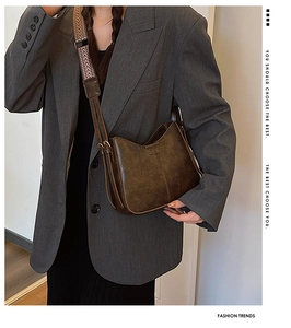 Deep brown bucket bag with textured herringbone wide strap and vintage gold hardware