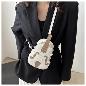 Chic white violin-shaped PU leather crossbody bag worn by model over a black suit