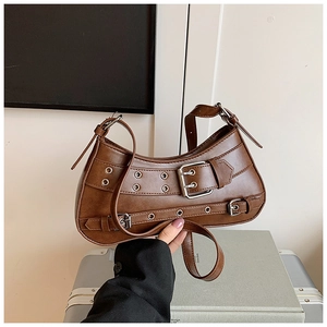 Close-up of dark brown Y2K shoulder bag with silver eyelets and buckle details