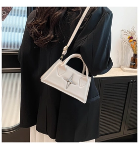 Détail du petit sac blanc structuré avec étoile argentée et fine bandoulière cuir