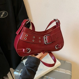 Deep red Y2K faux leather shoulder bag with silver eyelets and punk style buckles