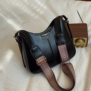Vintage black bucket bag with a stylish woven wide strap and golden hardware accents