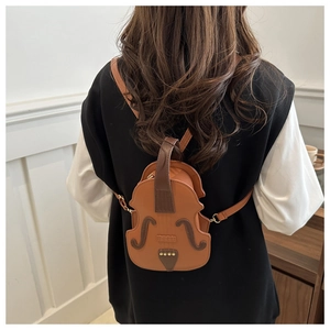 Detail of creative violin-shaped mini backpack with realistic strings and f-holes design