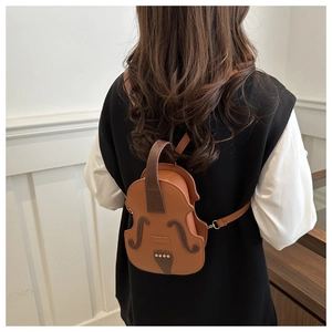 Detailed macro of a creative violin shaped crossbody bag in brown leather finish