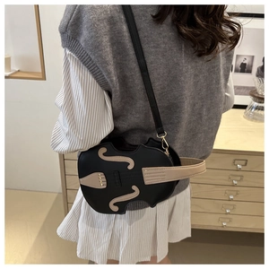 Detailed back view of a violin-shaped crossbody bag worn by a model in a minimal setting