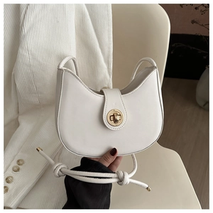 Detail of white leather crescent bag with golden twist lock and thin shoulder strap