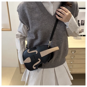 Detail view of the violin-shaped crossbody bag featuring PU leather and string details