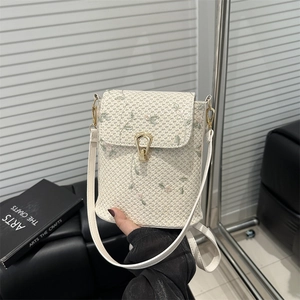 Vintage woven cream crossbody bag with floral embroidery and golden horseshoe lock