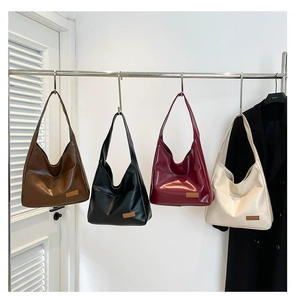 Selection of large minimalist hobo shoulder bags in brown, black, burgundy, and beige