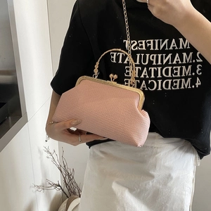 Pink woven clutch with gold metal clasp and ring handle, stylish evening chain shoulder bag