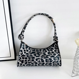 Close-up of leopard print hobo bag showing the knotted handle and metallic hardware
