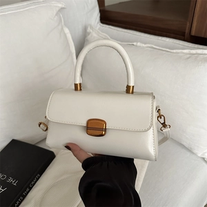 Vintage off-white leather square handbag with golden metal clasp and top handle
