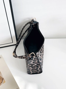 Internal view of leopard print shoulder bag showing spacious black lining and zipper
