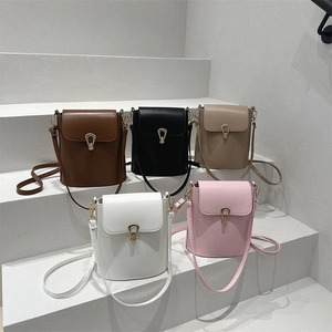 Minimalist bucket shoulder bags in five colors on concrete stairs for 2025 spring collection