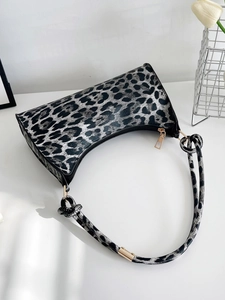 Detailed macro shot of leopard print faux leather texture with sleek golden zipper