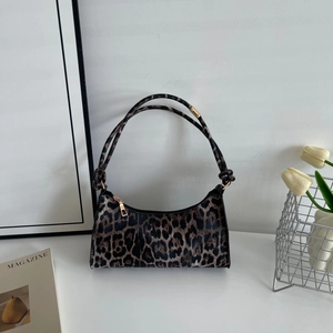 Fashionable leopard print shoulder bag displayed with elegant interior decor props