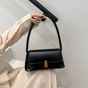 Minimalist black leather underarm bag with vintage gold buckle for urban women