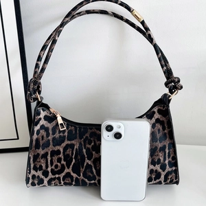 Fashionable leopard print underarm bag with gold zipper and knotted shoulder straps