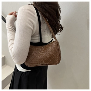 Close-up of brown woven texture and vegan leather craftsmanship on the hobo shoulder bag