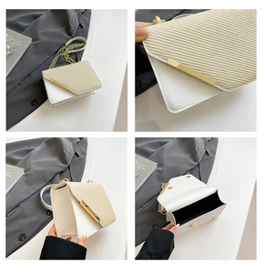 Detail view of beige chain crossbody bag featuring woven texture and gold magnetic clasp